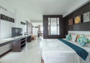 A modern hotel room with a large bed, a TV, a desk, and a view of the dining area. - The Wing Design Hotel (Bangkok)