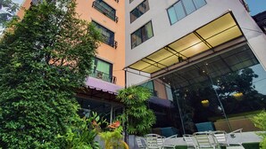 A multi-story building with a modern design, featuring balconies and large windows. - The Wing Design Hotel (Bangkok)