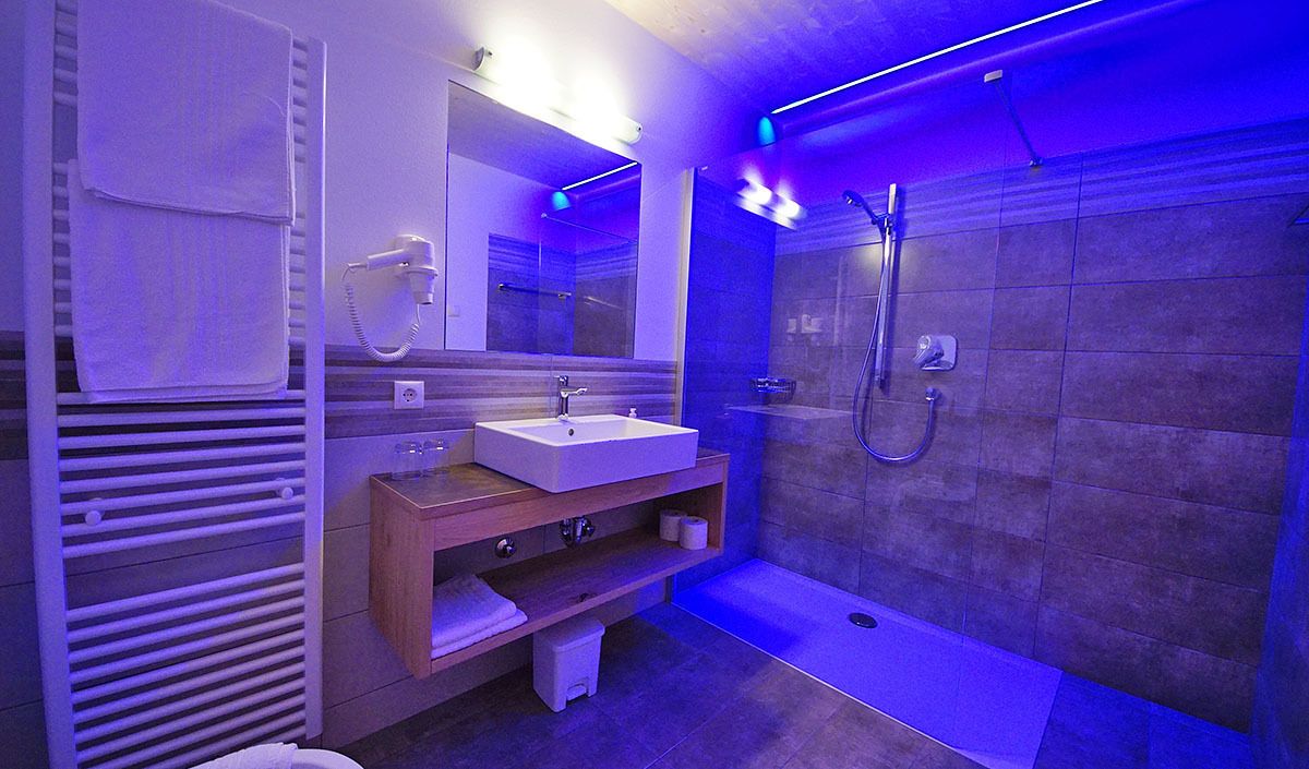 A modern bathroom with a bathtub, a sink, and a shower.