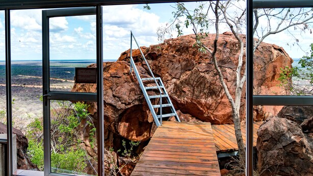 A wooden deck with a ladder leading to a rocky outcrop, overlooking a coastal landscape. - Waterberg Wilderness (Waterberg)