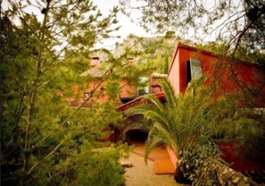 Standalone traditional building surrounded by lush greenery.