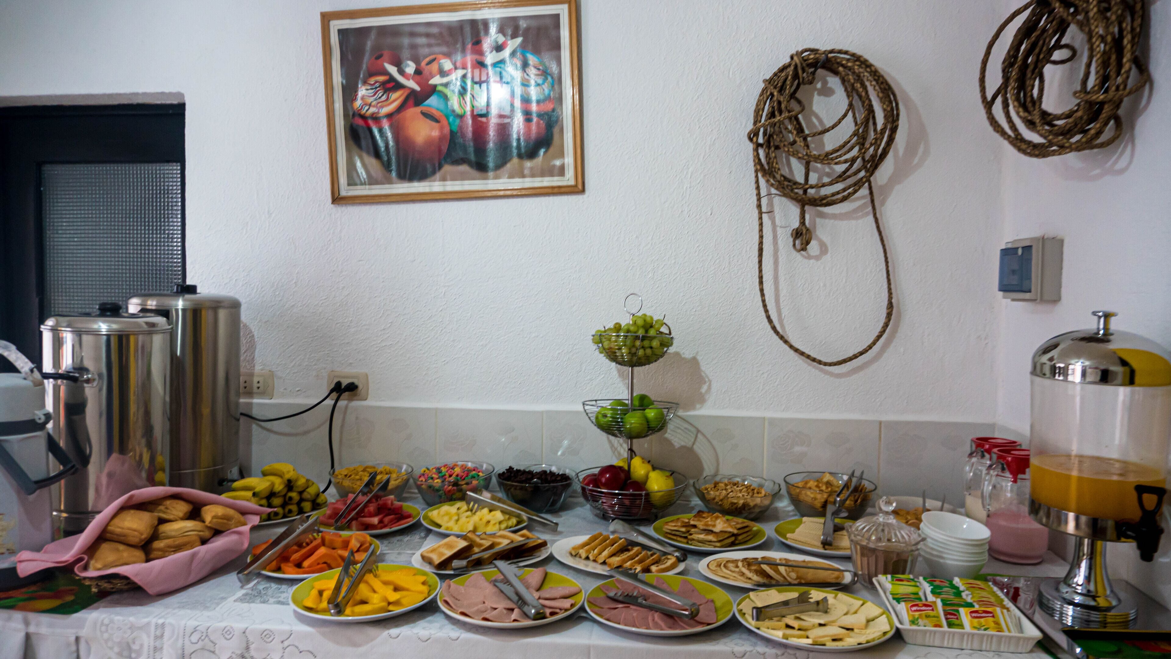 A buffet table with various food items and a coffee machine.