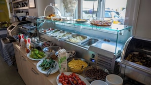 A buffet with various food items and a coffee station. - Artemis Hotel (Bodrum)