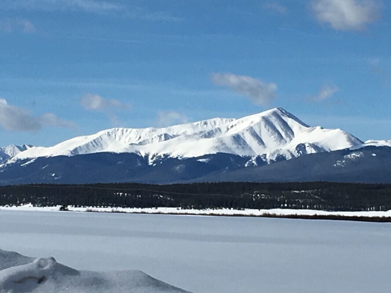 A snow-covered mountain range with a clear sky.