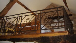 A wooden balcony with a wrought iron railing. - "La Bouyerie" cottage in a lovely setting, open countryside, breathtaking view (Najac)