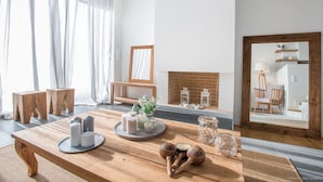 A wooden table with candles, a tray, and a mirror.