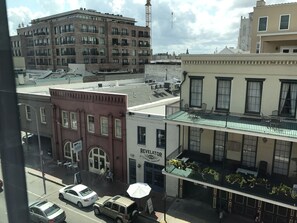 A multi-story building with a ground-level coffee shop named "Revelator Coffee Company" and a restaurant with outdoor seating. - Cambria Hotel New Orleans Downtown Warehouse District (New Orleans)