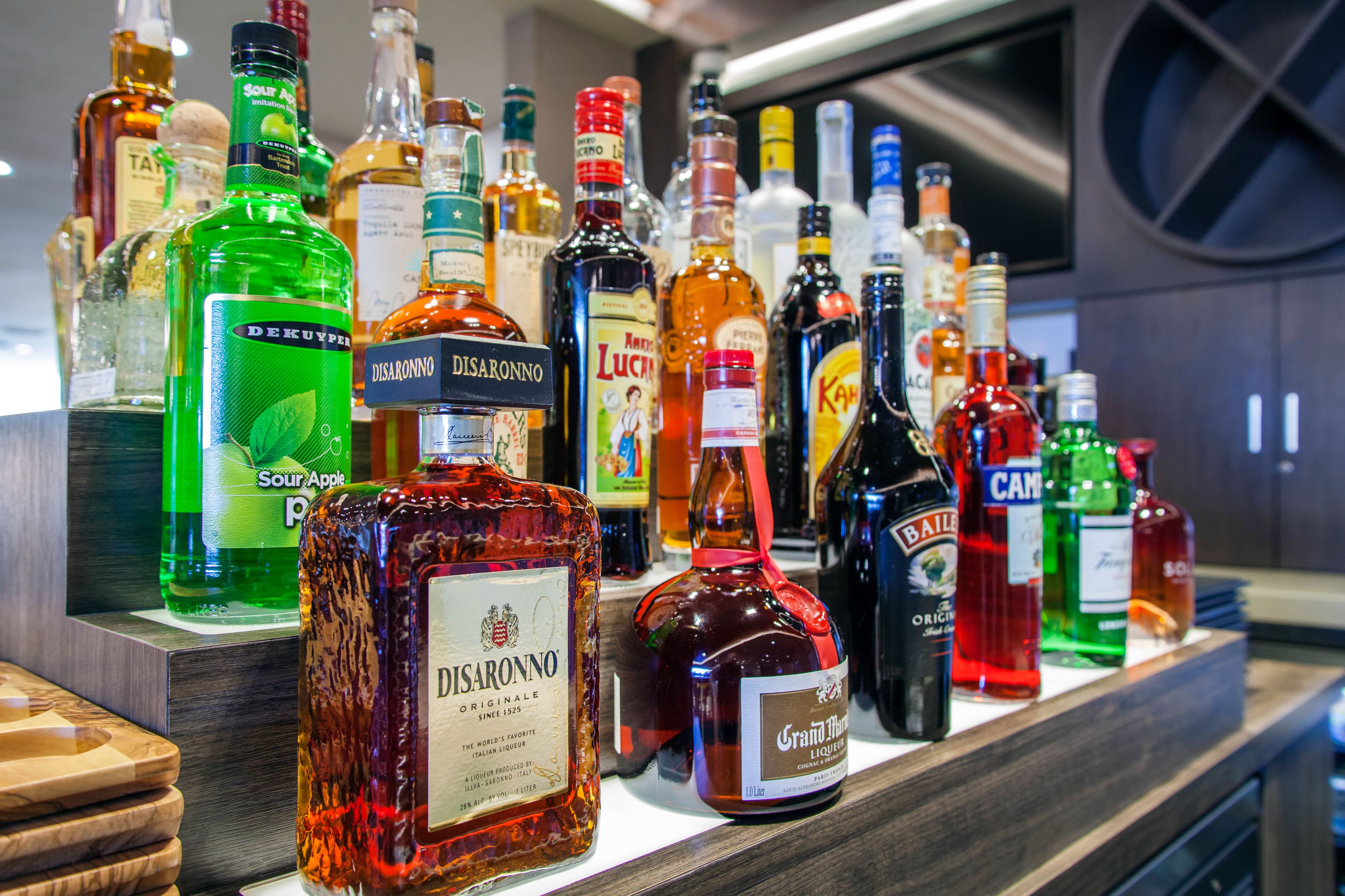 A variety of liquor bottles displayed on a shelf.