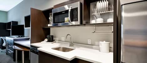 A modern kitchen with stainless steel appliances, a dishwasher, and a sink.