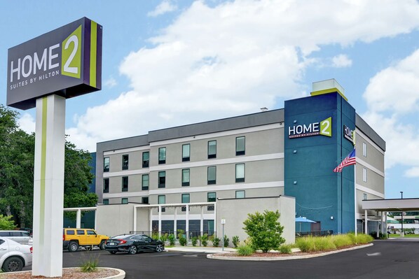 A modern hotel building with a sign reading "HOME 2 Suites by Hilton." - Home2 Suites by Hilton Pensacola I-10 at North Davis Hwy (Pensacola)