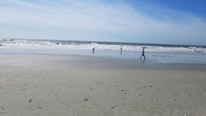 A beach with a wide sandy area and a clear sky. - Beautiful Large Two Story Condo Near The Beach With Unique Pricing! (North Myrtle Beach)
