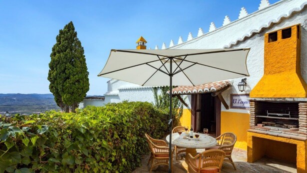 A patio with a table and chairs, a grill, and a view of the landscape. - Beautiful House with Private Pool near the Costa del Sol (Alcaucín)