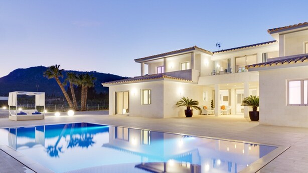 A modern two-story house with a swimming pool, large windows, and a mountain backdrop. - Villa with detached house, air conditioning, wifi, garden, private swimming pool (Inca)