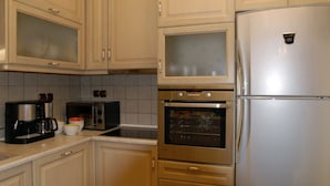 A kitchen with a stainless steel refrigerator, a built-in oven, a microwave, and a coffee maker. - Miression Pelion House (Mouresi  Pelion)
