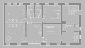 Een plattegrond van een hotel met meerdere kamers, een centrale hal en een eetruimte.