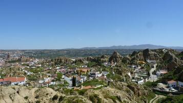 A town nestled in a valley with rugged terrain and rocky outcrops.