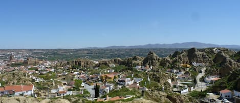 A town nestled in a valley with rugged terrain and rocky outcrops.