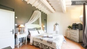 A bedroom with a bed, bedside tables, a wardrobe, and a television. - House Gordes. Classified 4☆ tourism (Gordes)