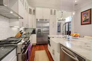 Enjoy cooking in this well-equipped kitchen with a refrigerator, oven, and gas stove.