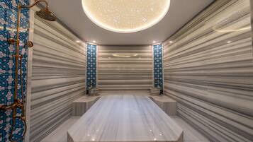Bathroom features a central sink and a shower with a gold showerhead.