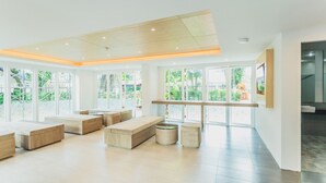 A spacious, modern interior with large windows, wooden furniture, and a clean, bright atmosphere. - Condo in Kata in Ozone - Unit A606 (Karon)