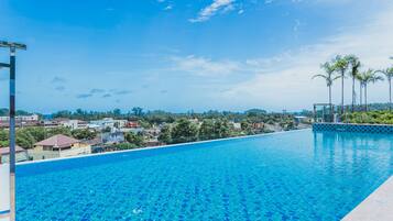 Outdoor pool, a rooftop pool, pool umbrellas, pool loungers