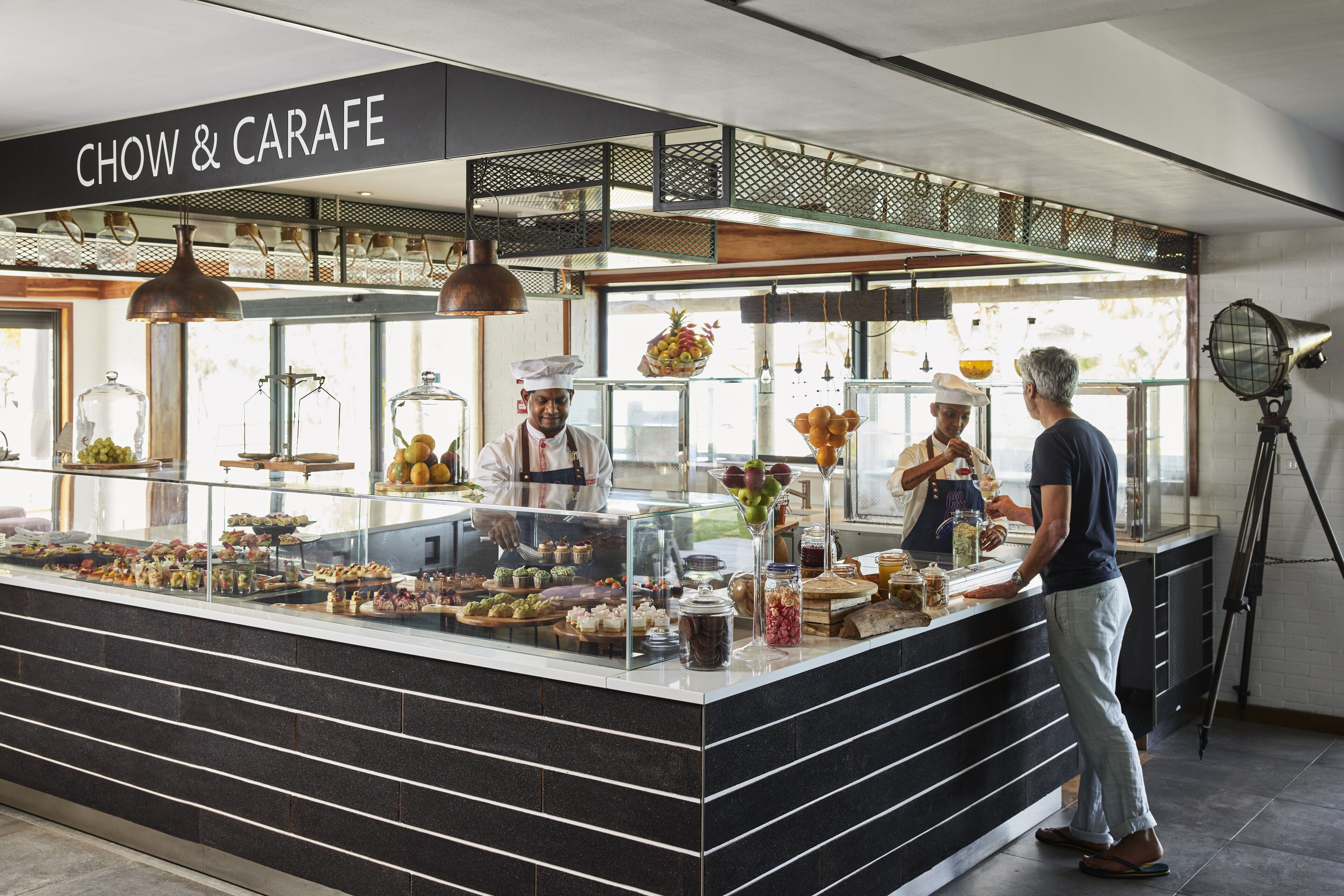 A food counter with a sign reading "CHOW & CARAFE".