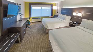 A hotel room with two beds, a desk, a chair, a TV, and a window with a view.