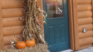 A wooden building with a sign reading "ENTRANCE" above a door. - Oak Creek Lodge (Bannister)