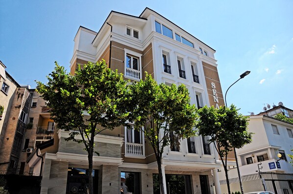 A multi-story building with a classic architectural style, featuring balconies and large windows. - Senator Hotel (Tirana)