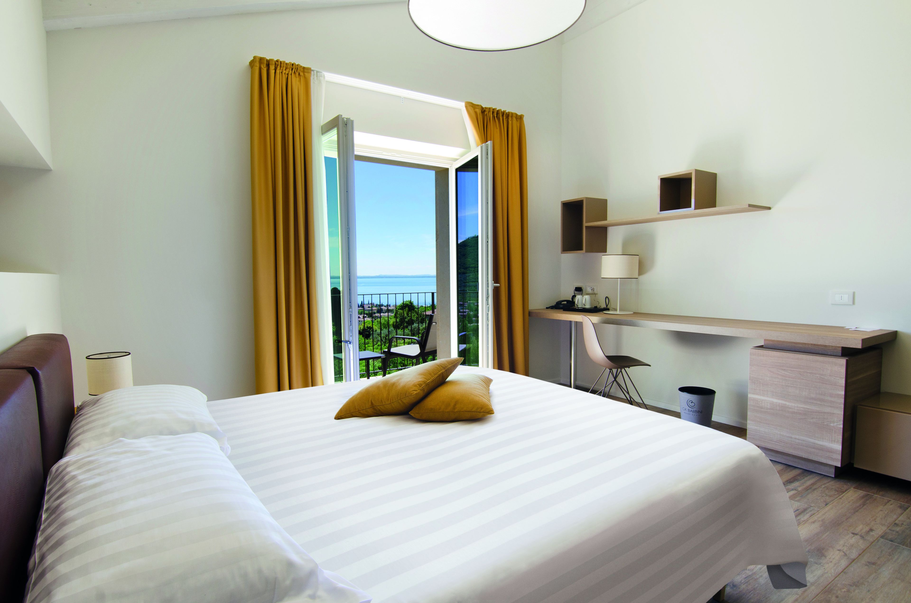 junior suite, balcony, lake view | premium bedding, minibar, in-room safe, desk