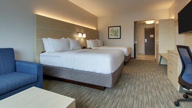 A hotel room with a large bed, a desk, a chair, and a television. - Holiday Inn Express and Suites-Elizabethtown North by IHG (Elizabethtown)