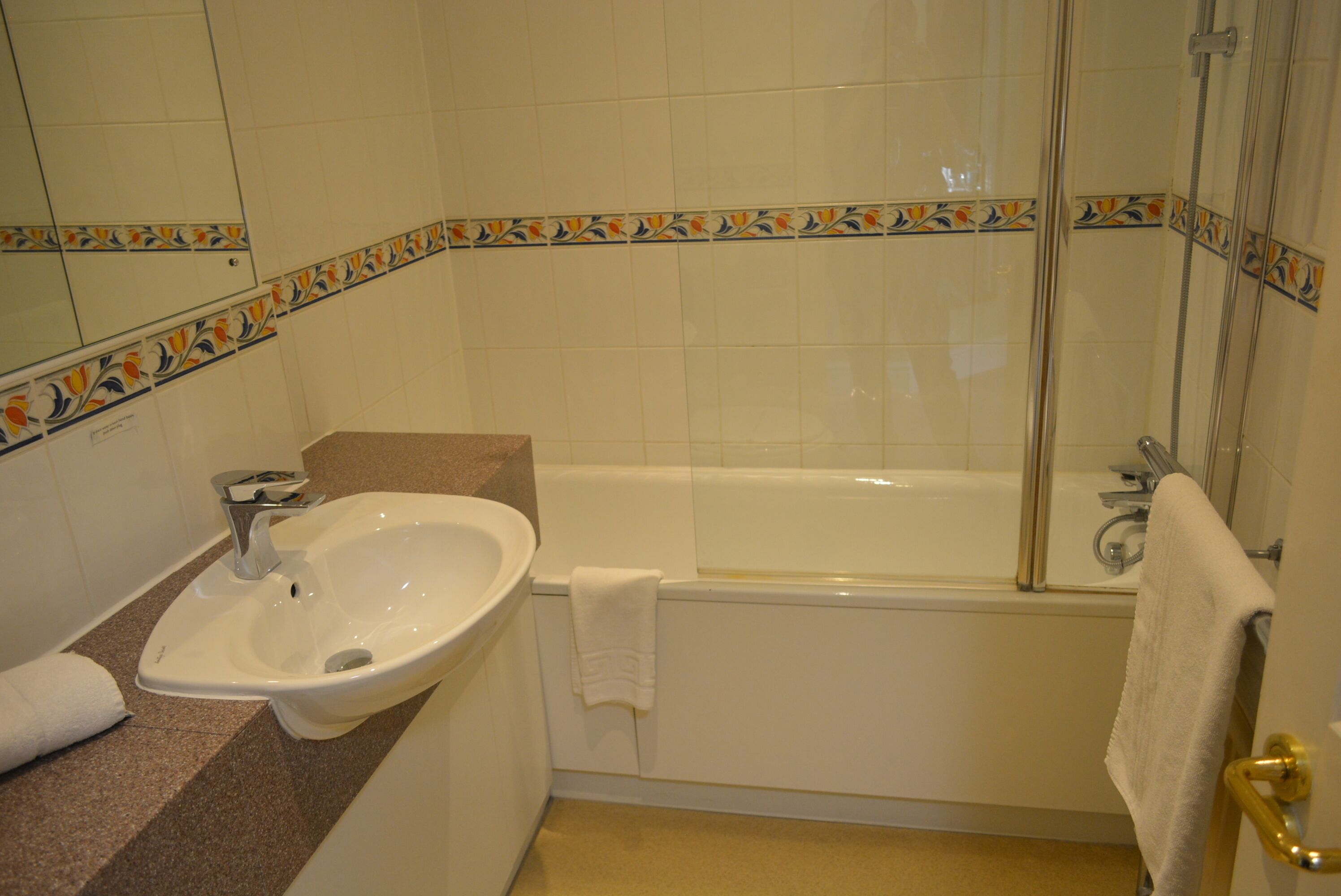 A bathroom with a sink, bathtub, and shower.