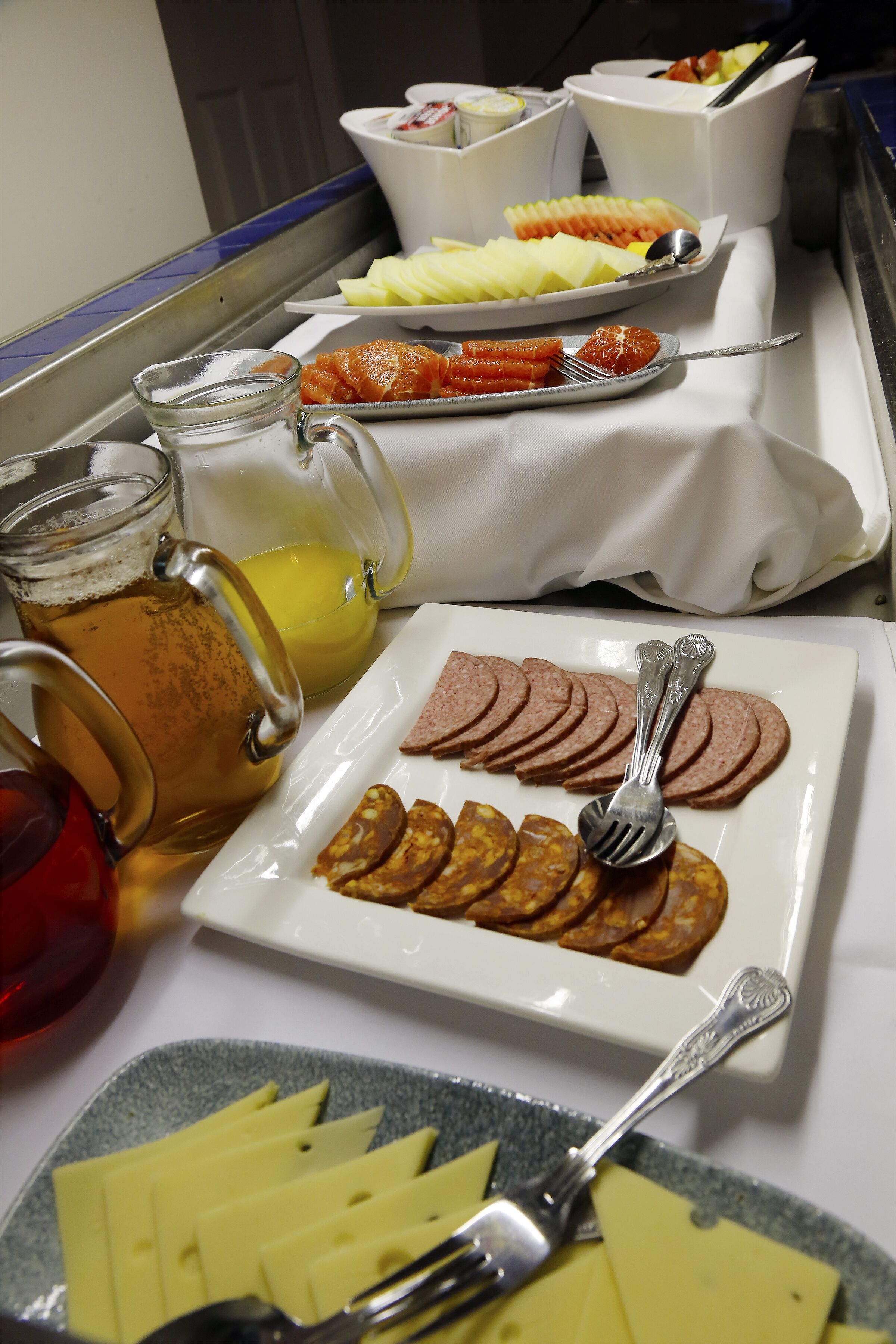 A breakfast buffet with various food items and beverages.