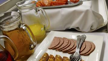 A breakfast buffet with various food items and beverages.