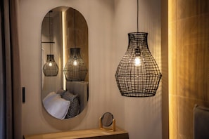 A bathroom with a round mirror, a wooden vanity, and three pendant lights with a woven design. - Sunny Hill Adults Only16+ by Estia (Hersonissos)
