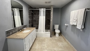 Room, 2 Double Beds | Bathroom | Deep-soaking bathtub, towels