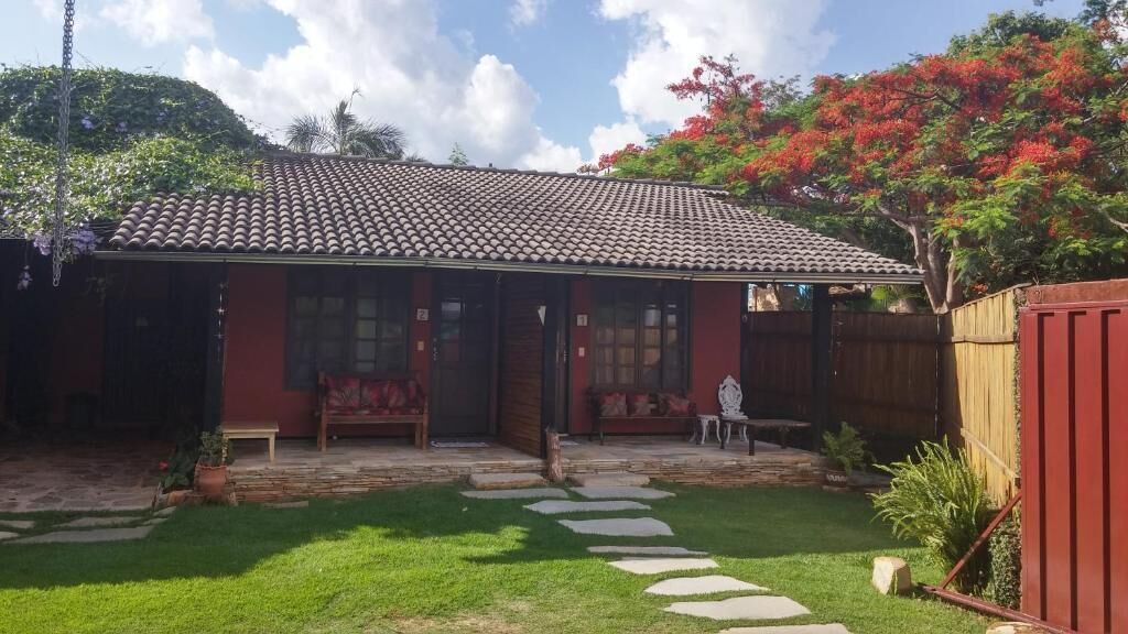 A house with a tiled roof, a front porch, and a small garden with stepping stones.