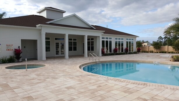 A house with a swimming pool, a covered patio, and a fenced yard. - Modern,Stylish & Minutes from Disney (kissimmee)