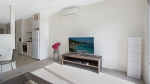 A modern kitchen with white cabinets and a built-in oven. - Astra Apartments Glen Waverley at VIQI (Glen Waverley)