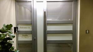 A set of double doors with a sign indicating 'Entrance to Studio 1, 2 & 3'. - Segovia Studio Units (Carolina)
