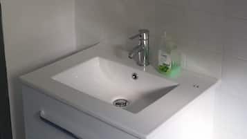 Bathtub, hair dryer, towels, soap