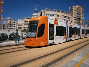 A tram with the number 4211 on a tram track.