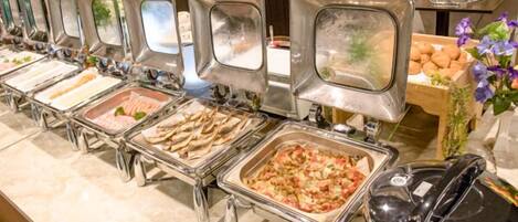 A buffet with various food options, including seafood and a casserole dish.