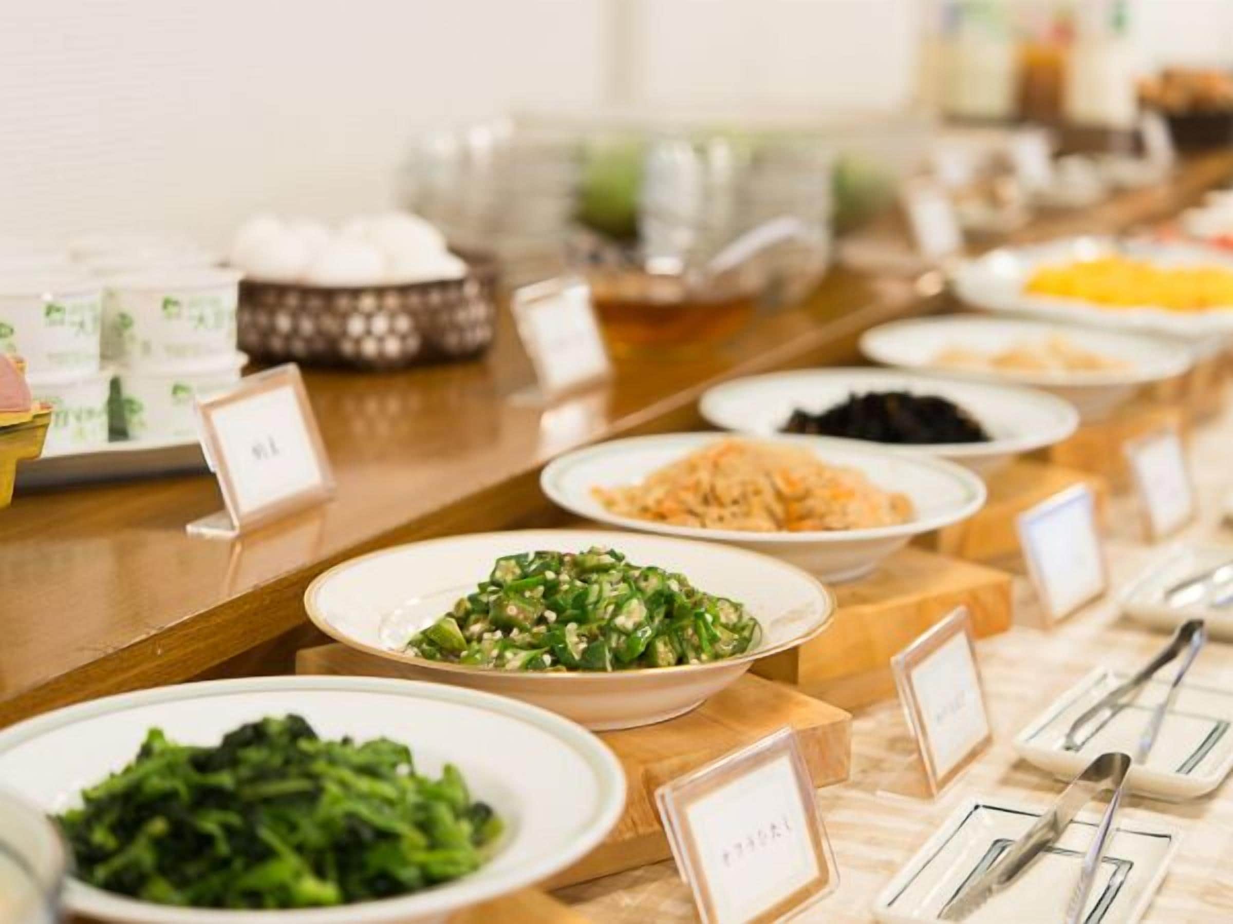 A buffet with various dishes and utensils.