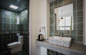 A bathroom with a toilet, a sink, and a shower.