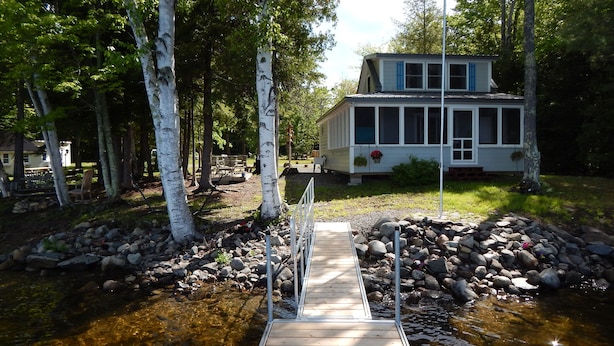 A wooden dock leading to a house surrounded by trees. - 10 Steps And You're  In Sebasticook Lake. This Is Where You Go To Unplug (Newport)