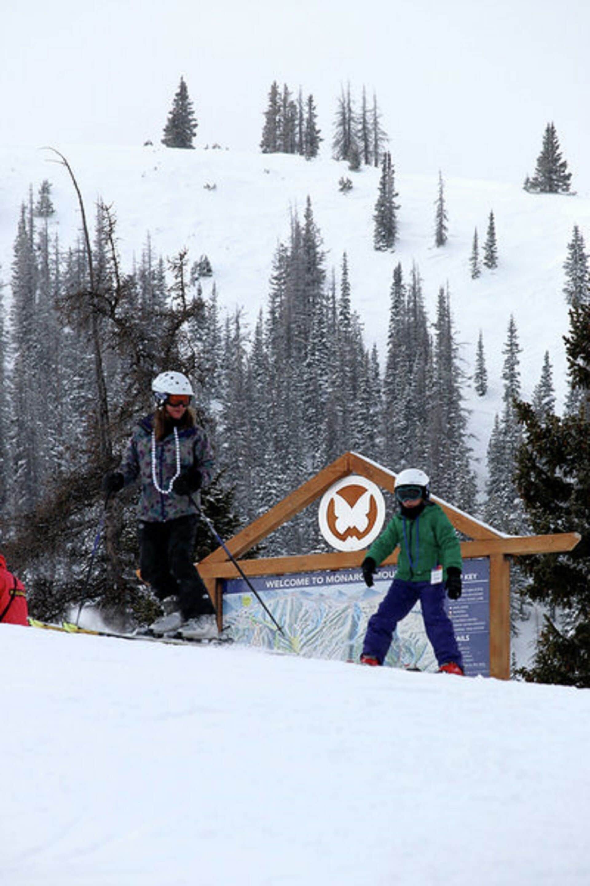 A ski resort sign with a welcoming message.