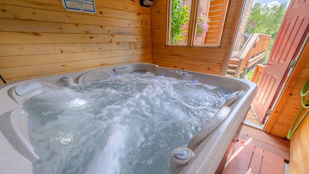 A wooden cabin with a hot tub. - Ski Town Condos - Mountain Comfort in Monarch/Garfield, Colorado (Salida)