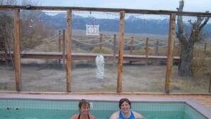 Two people in a swimming pool with a view of mountains in the background. - Ski Town Condos - Mountain Comfort in Monarch/Garfield, Colorado (Salida)
